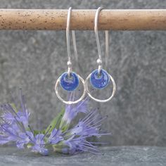 These hoop earrings were handmade from sterling silver and a navy blue enamelled silver disc.  I have hammered the silver hoop to give it added texture and a bit of sparkle. These silver earrings would be a lovely Mothers day gift or Valentines gift.  They are also available in a pale blue colour https://www.etsy.com/uk/listing/627277950/silver-and-enamel-earrings-sterling?ref=shop_home_active_1 although I can make them in the colour of your choice.  Please message me to arrange a different colour if required. You will receive these earrings gift wrapped. Click here to return to Thistledown Wishes home page https://www.etsy.com/uk/shop/ThistledownWishes?ref=seller-platform-mcnav. Click here to see more earrings https://www.etsy.com/uk/shop/ThistledownWishes?ref=seller-platform-mcnav§ion_id Blue Enamel Earrings, Silver Circle Earrings, Long Silver Earrings, Hoop Earrings Silver, Enamel Earrings, Hammered Silver, Enamel Jewelry, Etsy Earrings Dangle, Valentines Gift