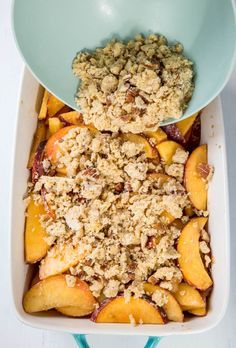 peach cobbler with crumbled oatmeal topping in a blue dish