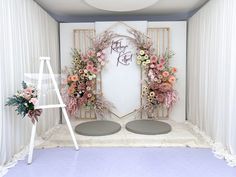 a white room decorated with flowers and plants