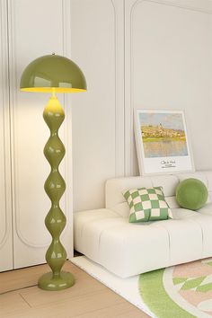 a green lamp sitting on top of a white couch