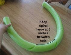 a person is making a fake banana out of foam on a wooden table with the words keep spiral large at 6 inches between cuts