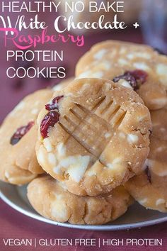 a plate with cookies on it and the words healthy no bake white chocolate raspberry protein cookies