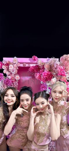 four girls in pink dresses posing for the camera