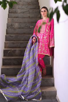 Channeling the old world charm of a kalidar kurta paired with shalwar, Serina is a striking hot pink number cut from pure rawsilk. The undulating trail of the geometric lime green and lavender contrasting organza dupatta hones in the ethereal aura. Model height: 5'3 Length: 38" Cut: relaxed fit In this price range, the Festive Slub Silk Salwar Kameez With Naqshi, Festive Naqshi Slub Silk Salwar Kameez, Festive Tissue Silk Salwar Kameez With Naqshi, Green Naqshi Dupatta For Festivals, Festive Tissue Silk Dupatta With Naqshi Detailing, Anarkali Tissue Silk Kurta With Naqshi Detailing, Pink Churidar With Naqshi Straight Kurta, Pink Unstitched Churidar With Naqshi, Green Silk Dupatta With Naqshi Detail