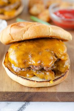 a cheeseburger on a wooden cutting board