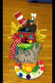 a multi - tiered cake decorated with an elephant and cat in the hat theme