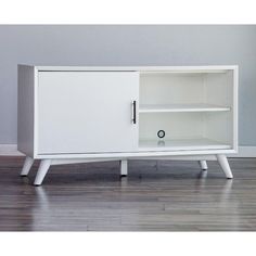 a white cabinet sitting on top of a hard wood floor