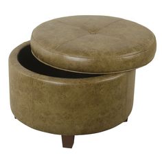 a round ottoman sitting on top of a wooden table