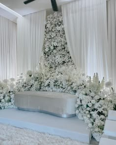 a white wedding stage with flowers on it