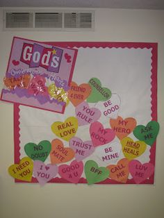 a bulletin board with candy hearts and god's love on it in front of a window