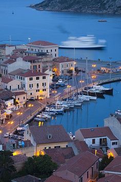 a harbor filled with lots of boats next to buildings