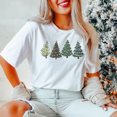 Comfort Colors® Green Christmas Tree Shirt, Christmas Tree Shirt, Christmas Party Shirt, Christmas Gift, Xmas Party Tee, Xmas Gift A Comfort Colors shirt is a type of casual t-shirt that is known for its softness, relaxed fit, and muted color palette. Typically made from 100% cotton, these shirts have a vintage feel and are often favored for their comfortable, worn-in look. This classic unisex jersey short sleeve and long sleeve tees fits like a well-loved favorite. Soft cotton and quality print Casual Christmas Festive Shirt, White Festive Shirt For Christmas, White Short Sleeve Christmas Shirt, White Festive Christmas Shirt, White Festive Holiday T-shirt, White Festive Holiday Top, Festive White Holiday Top, Christmas Holiday Crew Neck Shirt, Green T-shirt For Christmas Holiday