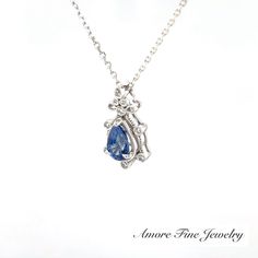 This Ornate Sapphire Diamond Pendant Has One Pear Shape Sapphire Weighing .89 Carat, Along with Nine Round Brilliant Cut Diamonds Weighing .08 Carat Set in 14k White Gold. Comes with Standard 18" 14kt White Gold Cable Chain Weighing 1.18 Grams. Classic Sapphire Diamond Necklace For Formal Occasions, Sapphire Necklace For Anniversary, Classic Sapphire Necklace For Formal Occasions, Classic Formal Sapphire Diamond Necklace, Elegant Tanzanite Necklaces For Anniversary, Pear-shaped Sapphire Necklaces For Anniversary, White Gold Tanzanite Necklace For Anniversary, Anniversary White Gold Tanzanite Necklace, White Gold Tanzanite Necklace For Formal Occasions