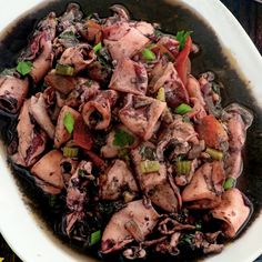 a white bowl filled with squid and vegetables