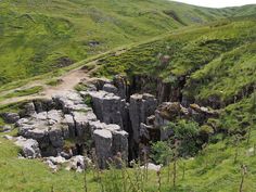 a large rock formation in the middle of a field