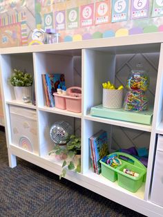 there are many toys on the shelves in this child's playroom, including books and toys