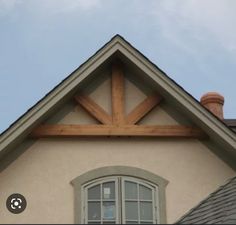 the roof of a house with a wooden cross on it