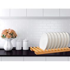 a black counter top with plates and vases on it