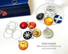 wine charms are sitting on a table next to a box