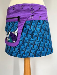 * Reversible wrap skirt which can be worn on both sides. * Snaps at the waist allow you to adjust the size to your exact fit. * Size can be adjusted to fit from XS to XXL. * The pocket clips off and can be attached to either side of the skirt. * Can be worn without  the pocket. Pocket fits phone, keys, wallet easily. * Very High quality finish with vibrant colourfast prints. * Made from 100% Cotton * Best worn on the hips * Looks great  in Winter over leggings or with tights and boots.  -  Sizing - Freesize fits size Uk 6 TO Uk 18 because of adjustable waist. Fits waist 78cm to 120cm/30.5" to 47". Length 13.5"/35.29cm Machine wash at 30 degrees. * Each order is sent  in a  beautiful recycled  bag, designed by Ananda Clothing and made from leftover cuts. Layered Winter Outfits, Reversible Wrap Skirt, Reversible Skirt, Wrap Mini Skirt, Tights And Boots, Boho Stil, Skirts With Pockets, Christmas Gifts For Her, Blue Print