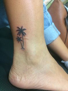 a small palm tree tattoo on the ankle