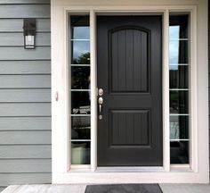 a black front door on a gray house