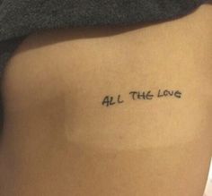 a woman's stomach with the words all the love tattooed on her lower back