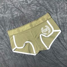 Olive Green With White Trim Pink Crest Logo On Front Left Soft Cotton Low Rise Curved Hem Binding At Leg Pink Logo Waistband Imported Cotton/Spandex Stretch Short Boxer Briefs With Letter Print, Stretch Boxer Briefs With Letter Print, Summer Letter Print Short Boxer Briefs, Casual Short Boxer Briefs With Letter Print, Stretch Letter Print Boxer Briefs For Loungewear, Green Cotton Boxer Briefs, Green Stretch Cotton Pajama Shorts, Trendy Short Boxer Briefs For Loungewear, Sporty Green Cotton Boxer Briefs