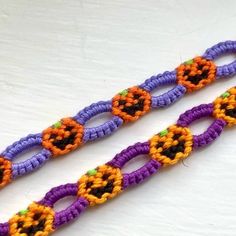 two crocheted bracelets with orange, purple and green beads on white surface