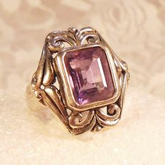 "Large Amethyst Solitaire Ring, Vintage Amethyst Ring, Signed 925 Sterling, Emerald Cut, Bezel Set, Heavy Silver, Bold Statement Ring. WOW!  That is what everyone will say when you wear this beautiful bold amethyst ring.  The large emerald cut amethyst is bezel set in a very art nouveau influenced swirling heavy sterling silver mounting.  This is a big heavy ring.   It is 1\" from top to bottom and from side to side and sits 1/2\" off the finger.   If you are looking for a statement piece this is definitely that.  It looks almost medieval in its heavy simplicity.  The stone is a gorgeous crystal clear emerald cut amethyst and really stand out against the sterling bezel it is set in.  As big and bold as it is the setting curves beautifully to fit the finger making the ring very comfortable Art Nouveau Ring Vintage, Vintage Amethyst Ring, Amethyst Ring Vintage, Antique Rings Vintage, Art Nouveau Ring, Ring Vintage, Amethyst Ring, Antique Rings, Perfect Ring