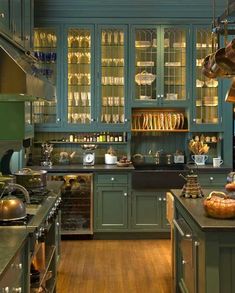 an image of a kitchen with green cabinets and wood flooring on the phone screen