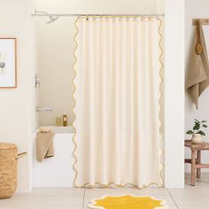 a bath room with a shower curtain and a rug