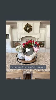 a kitchen with white cabinets and an american flag vase on the counter top in front of it