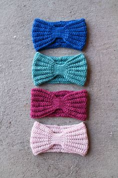 three crocheted bow ties laying on the ground