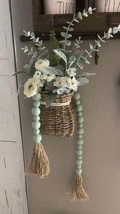 a basket with flowers hanging on the wall