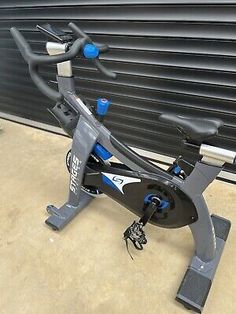 an exercise bike sitting in front of a garage door