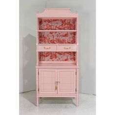 a pink hutch with shutters and drawers