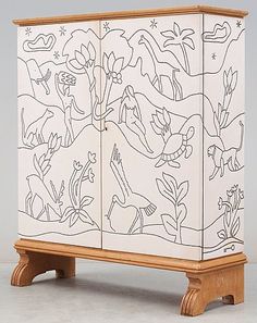 a wooden cabinet with an artistic design on it's front and side panels,