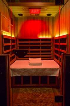 the inside of a small room with a bed and speakers on either side of it