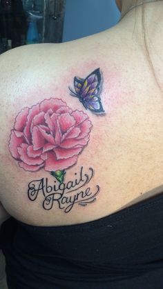 a woman with a butterfly and flower tattoo on her back shoulder, which reads abigail rayne