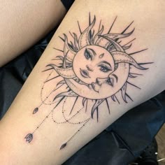 a woman's thigh with a sun and moon tattoo on it