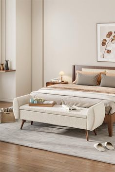 a bedroom with a bed, footstool and rug