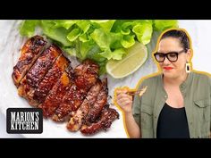 a woman holding a fork in front of ribs and lettuce