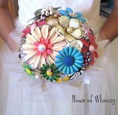 a bridal holding a bouquet of flowers in it's hands with the words house of whimsey written below