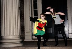 two women dressed as batman and robinette are posing on the steps in front of a building