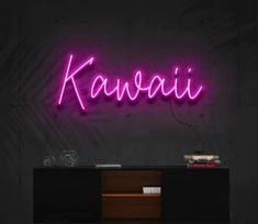 a purple neon sign that says kawaii on the side of a black wall