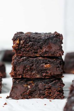 chocolate brownies stacked on top of each other with one bite taken out of it