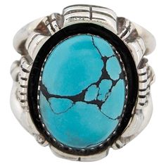 The Fort Griffin Ring, expertly crafted by Robert Drozd, is a testament to the artistry of fine jewelry making, featuring a vibrant turquoise stone prized for its unique pattern and rich history, set in sterling silver settings expertly designed to accentuate the gemstone's beauty. Reflecting exceptional craftsmanship and attention to detail, this ring is a true masterpiece that will be treasured for generations to come. With its unique combination of natural beauty and expert craftsmanship, the Southwestern Style Turquoise Oval Ring With Polished Finish, Southwestern Style Oval Turquoise Ring With Polished Finish, Unique Turquoise Rings With Polished Finish, Southwestern Polished Turquoise Ring, Southwestern Style Polished Turquoise Ring, Traditional Turquoise Rings Collectible, Artisan Oval Turquoise Ring With Polished Finish, Southwestern Turquoise Ring With Oval Cabochon, Southwestern Oval Cabochon Turquoise Ring