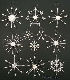 a group of white snowflakes hanging from strings