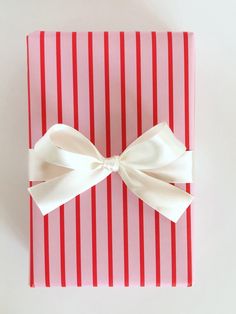 a red and white box with a bow on it